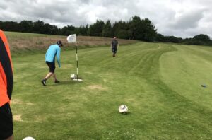 three men playing footgolf in Cluny, Scotland